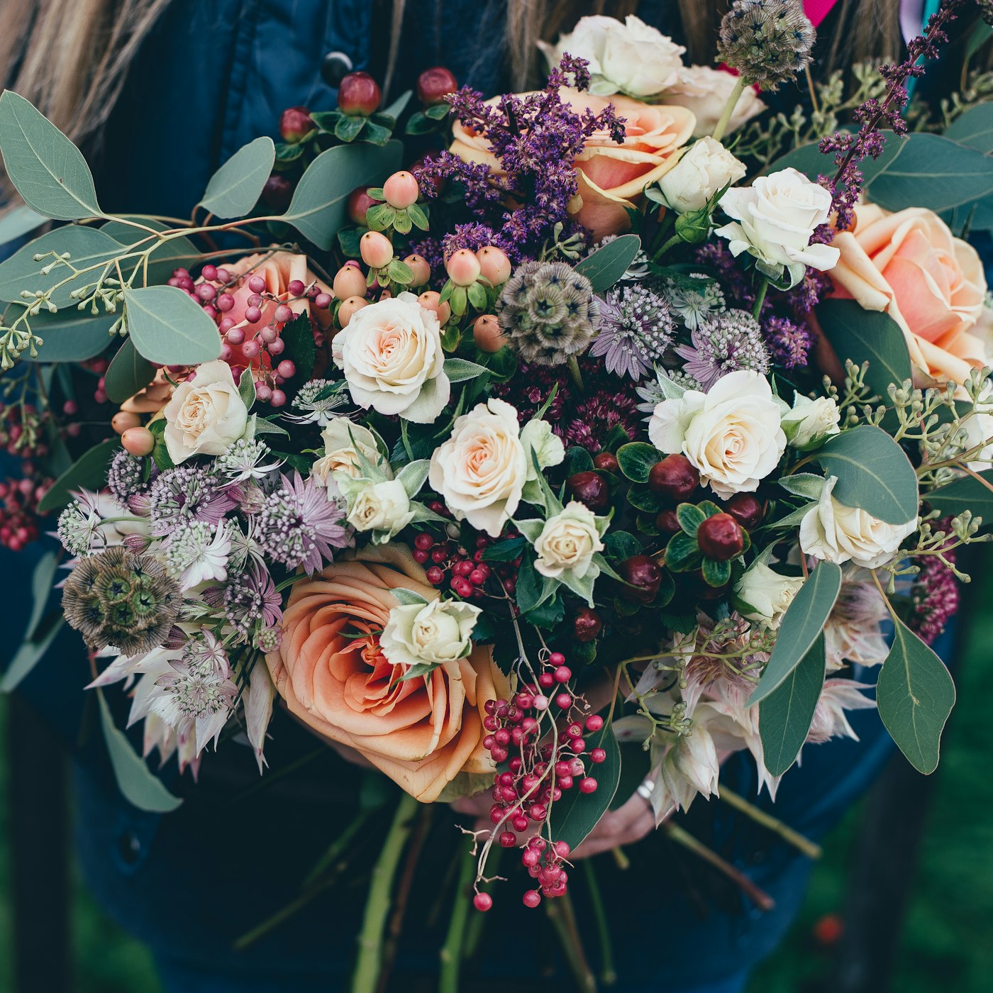 Florist wrapping a fresh bouquet by hand